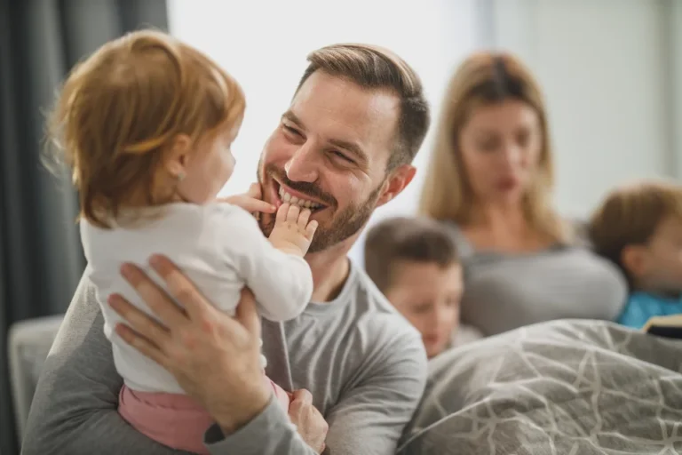 Happy family with young children at home