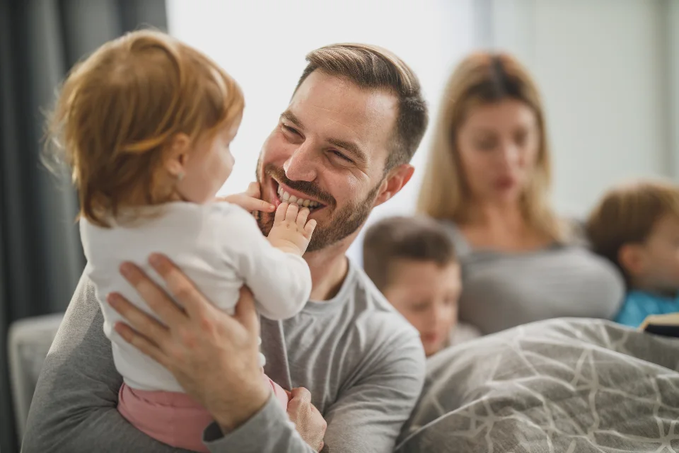 Happy family with young children at home