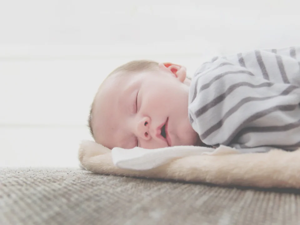 Sleeping newborn baby wrapped in a soft blanket