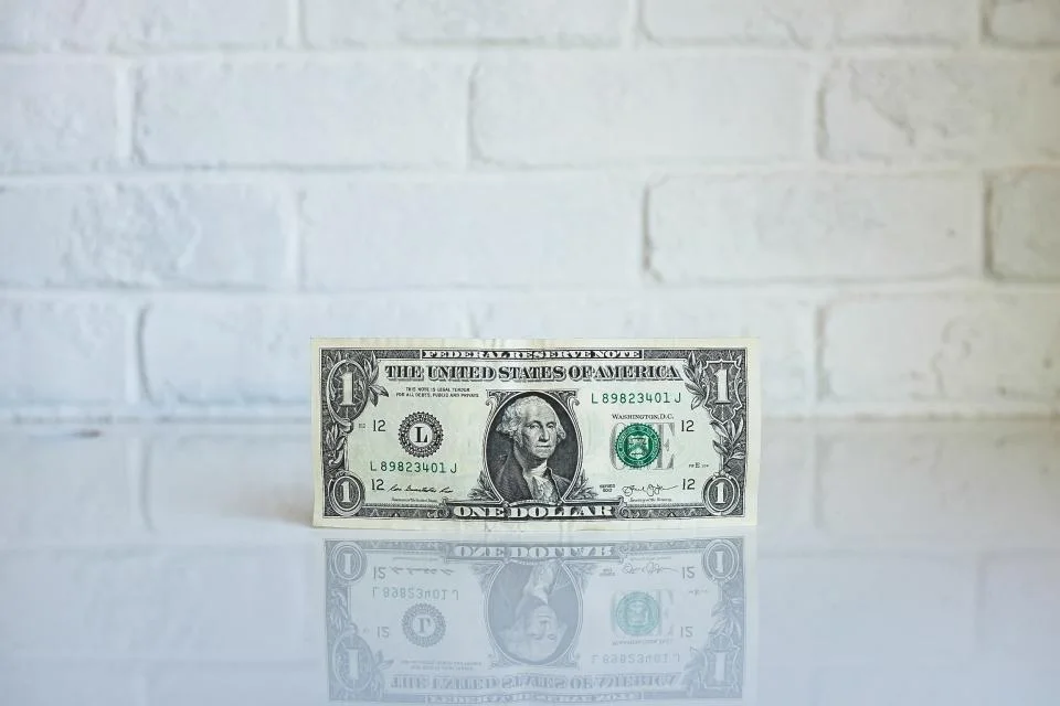 A dollar bill representing the cost of a rotating car seat